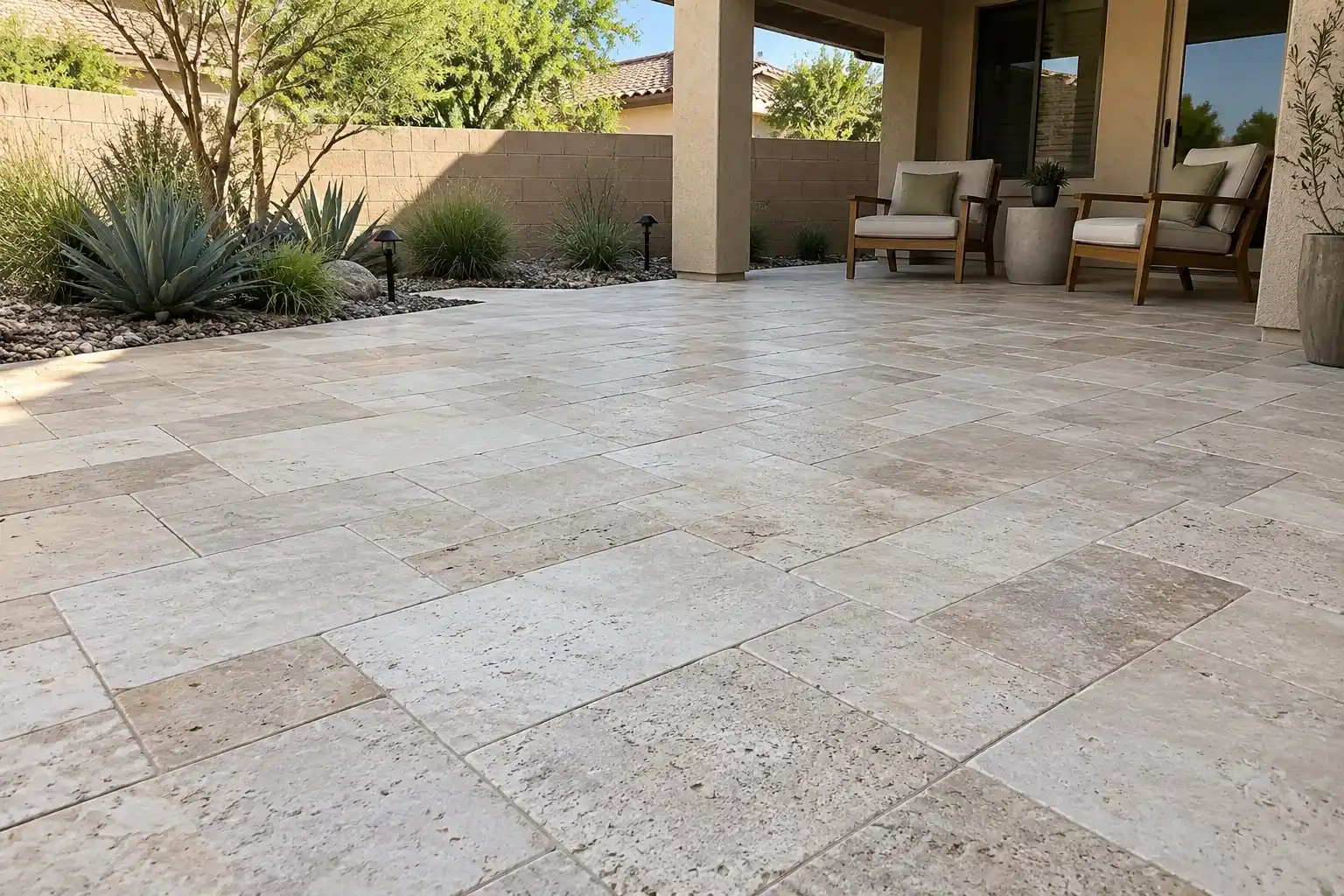 Covered patio of pale travertine in mixed-size stones
