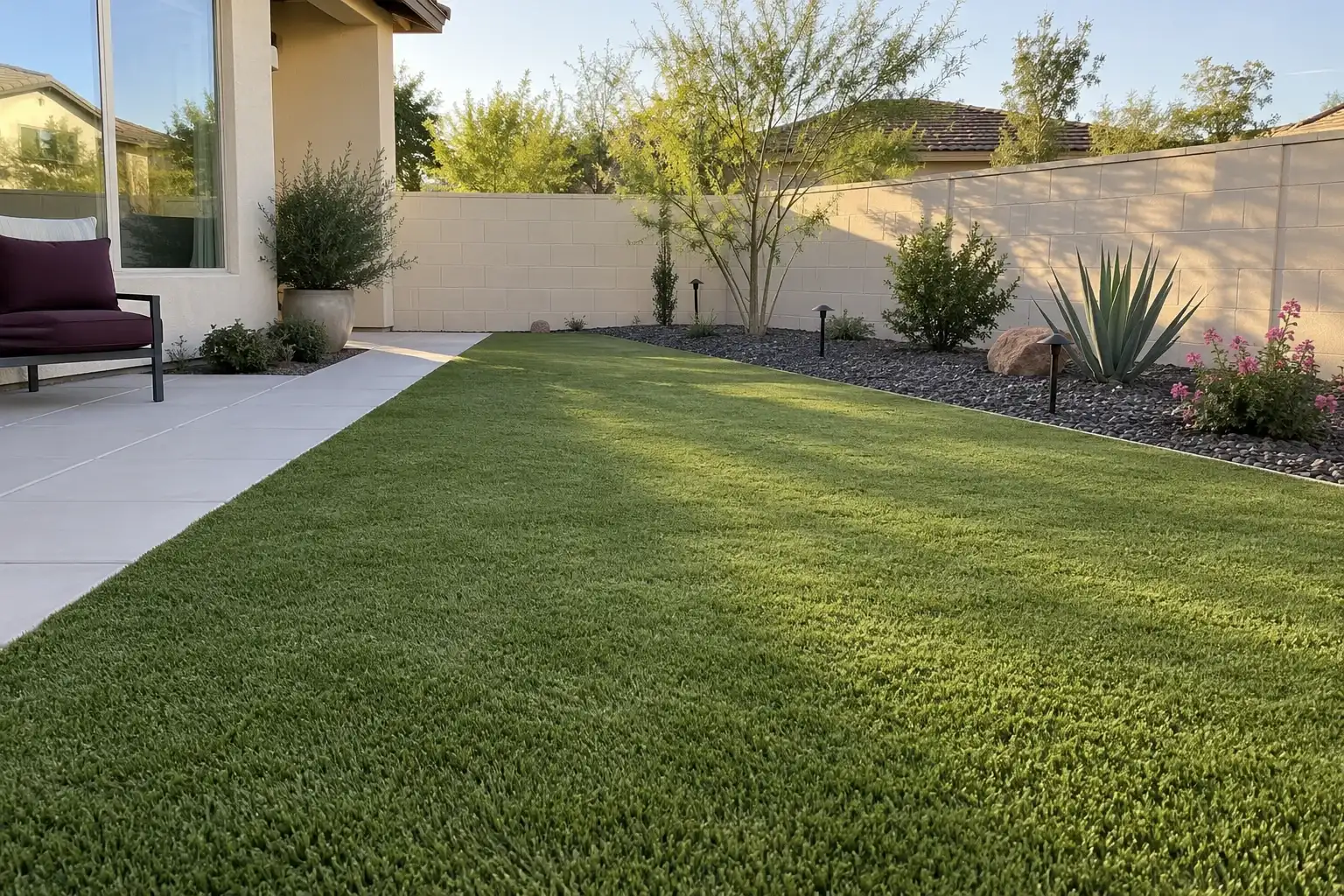 Rectangular short-pile artificial turf lawn beside a concrete walk